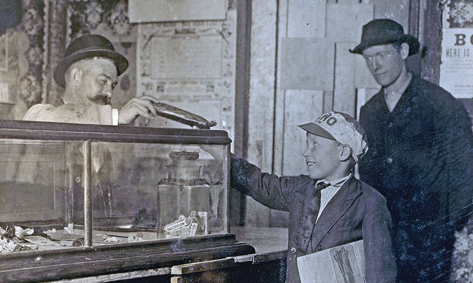 boy buying candy in an old west shop true west magazine